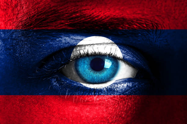 istock Human face painted with flag of Laos 933868506