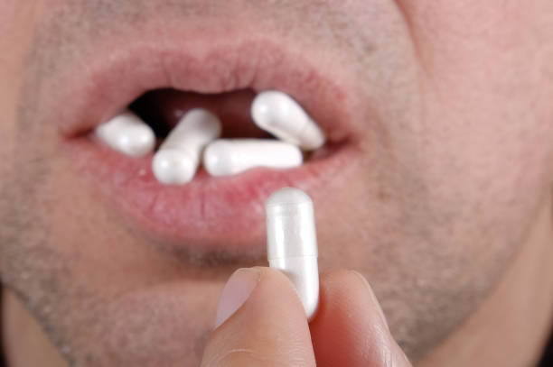 istock Mouth full of pills 933869354