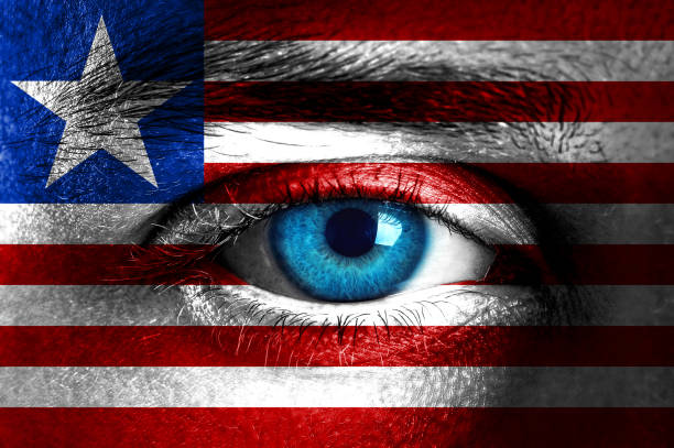 istock Human face painted with flag of Liberia 933874534