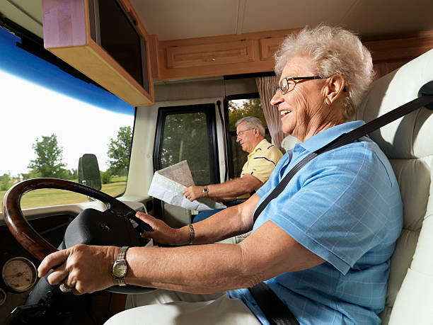 Senior woman driving RV. stock photo