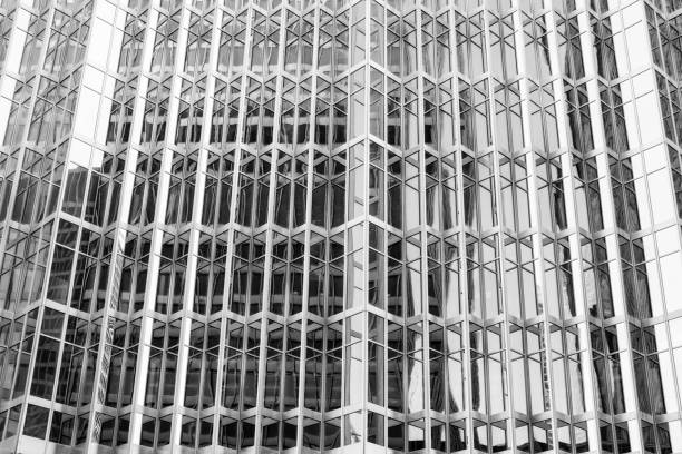 istock reflecting glass windows of a corporate business skyscraper 933877698