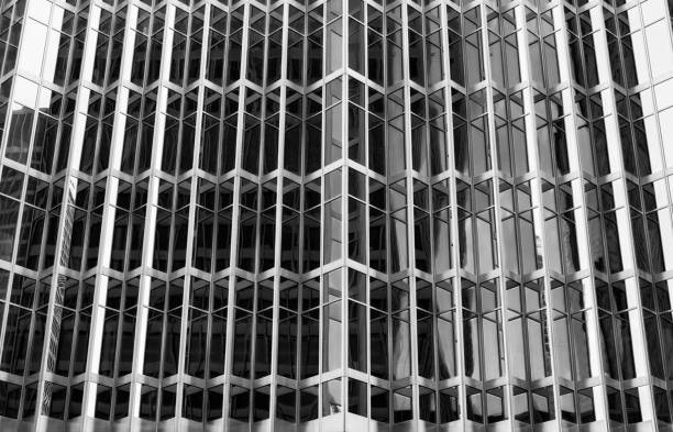 istock reflective windows of a urban high rise building 933877736