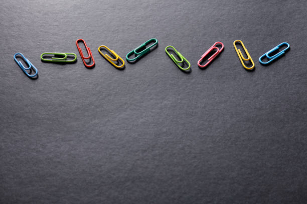 Close up view of paper clips on black background
