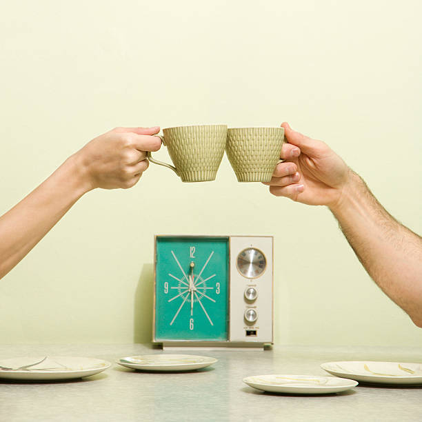Hands toasting with cups. stock photo