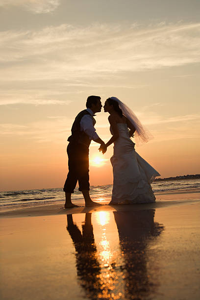istock Bride and groom kissing on beach. 93388212