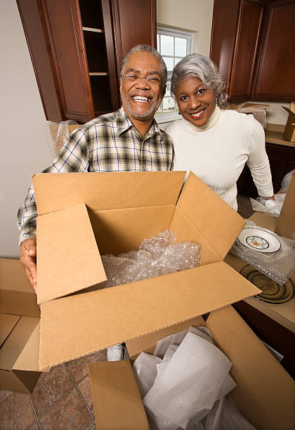 Senior couple unpacking boxes. stock photo