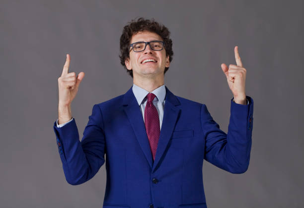 istock Happy boy showing with index fingers 933883348