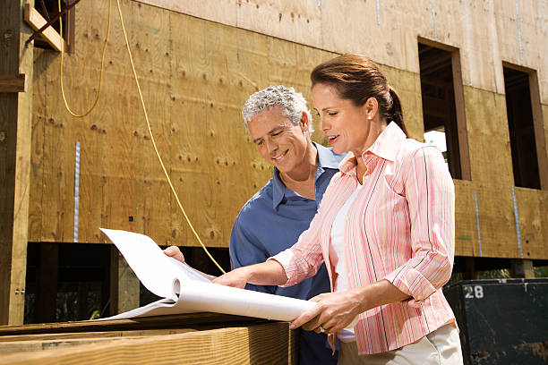 Man and woman on construction site. stock photo