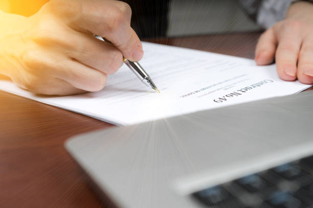 istock A businessman puts his signature on the contract. Copy space. 933886256