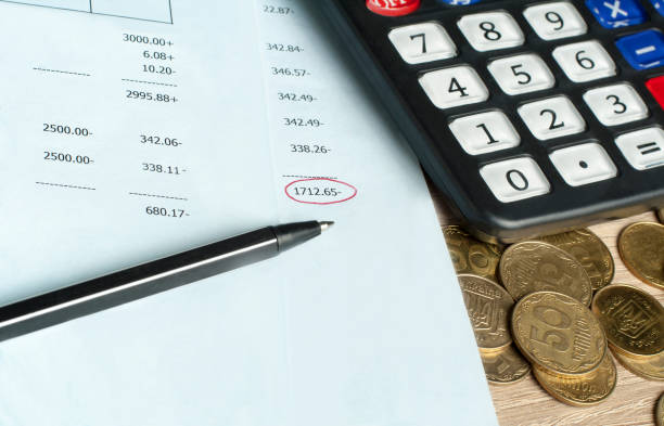 istock Finance and budget concept. Calculator, pen and coins on office table 933888484