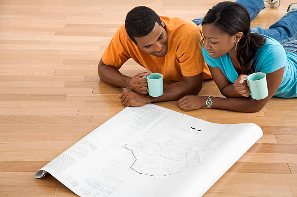 Couple looking at blueprints. stock photo