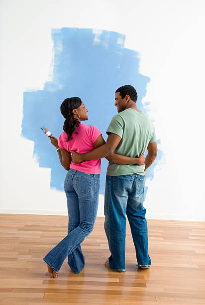 istock Man and woman looking at paint job. 93388983