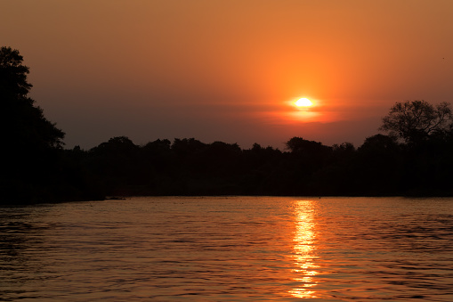 Watching the sun set in the Pantanal of Brazil is always a feast for the eyes.  As the sun disappears behind the forest it is reflected in the slow moving river and saturates the sky with orange and red hues.