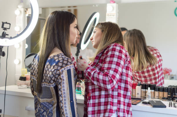 istock Make up artist applying make up on a girl 933894070