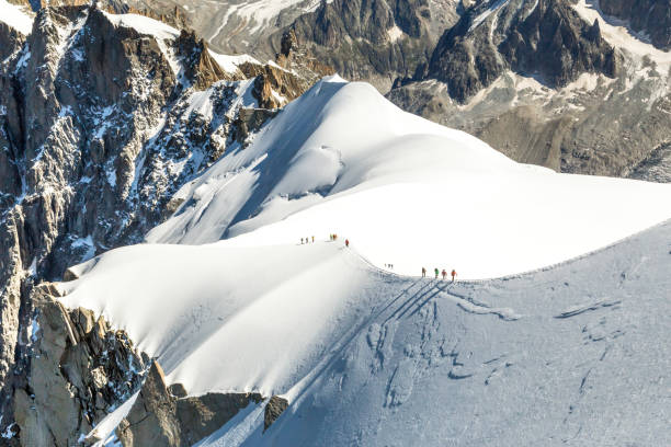 istock Mont Blanc mountaneers walking on snowy ridge. 933901812