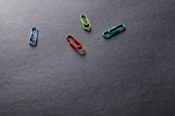 Close up view of paper clips on black background