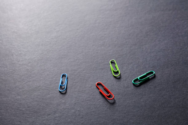 Close up view of paper clips on black background