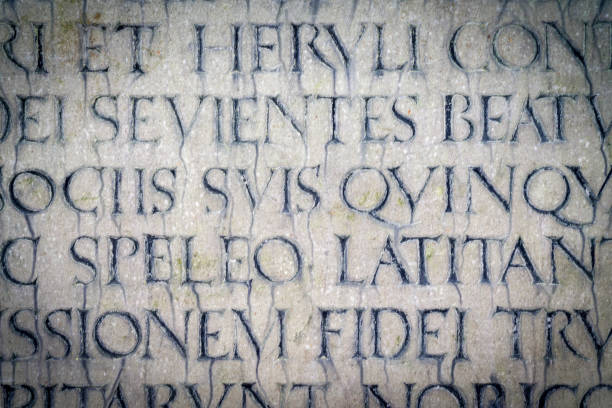 Roman text lettering engraved in stone close-up for backgrounds.
