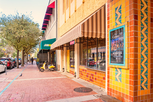 Man walks on the sidewalk in the entertainment district in downtown Tucson Arizona USA with the Fox Theater in the foreground.