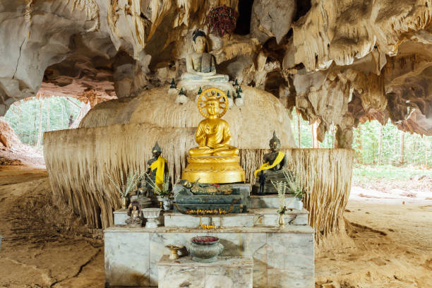 Image of Buddha in the cave Image of Buddha in the cave. Tiger Cave Temple, Krabi, Thailand. wat tham sua stock pictures, royalty-free photos & images