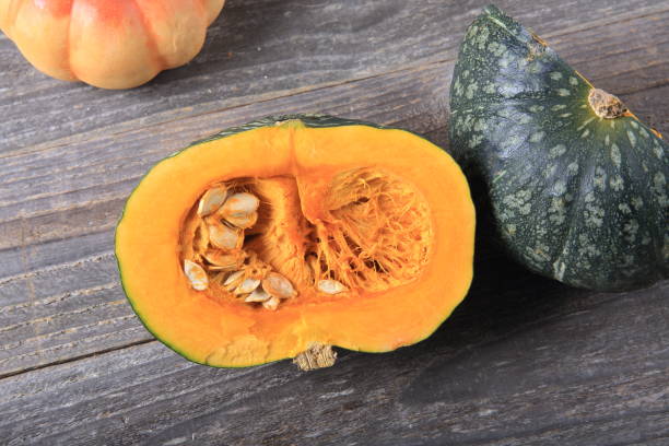 istock Green pumpkin on a wooden table 933929908