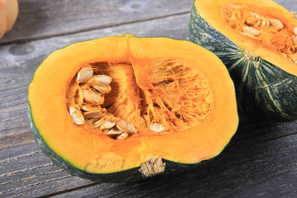 istock Green pumpkin on a wooden table 933929958