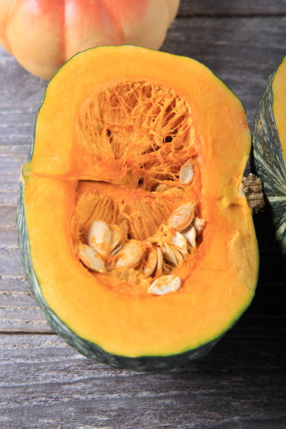 istock Green pumpkin on a wooden table 933929980
