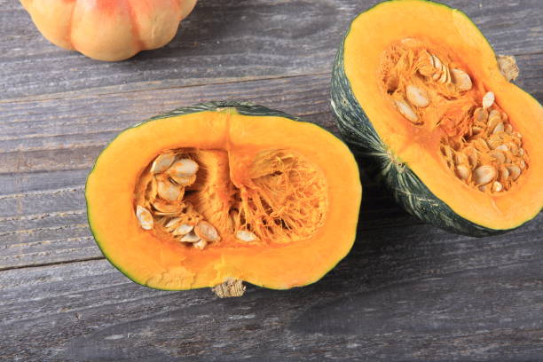 istock Green pumpkin on a wooden table 933930024