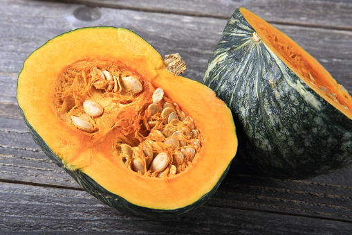 Green pumpkin on a wooden table