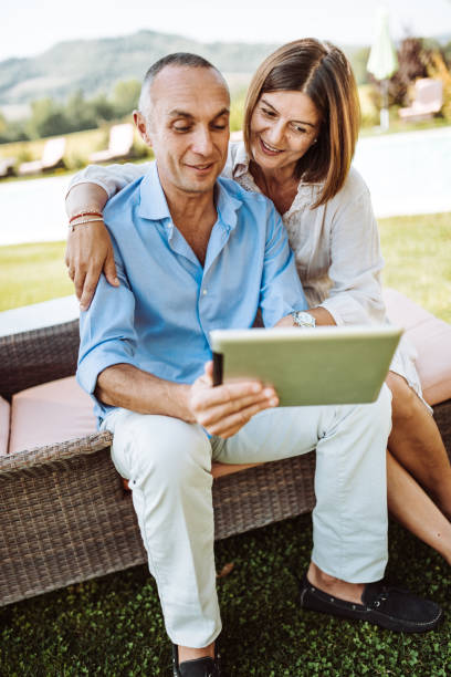 istock happiness couple using the tablet on the garden 933932526