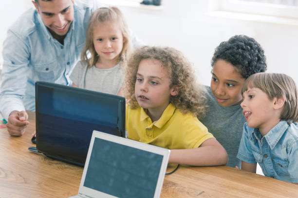Children working together on laptop