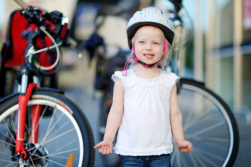 Little toddler girl ready to ride a bicycle