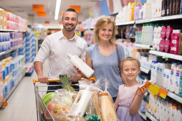 istock Parents with daughter selecting cleaning products 933952172