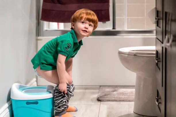 istock Happy Cute Redhead Little Boy Potty Training 933955098
