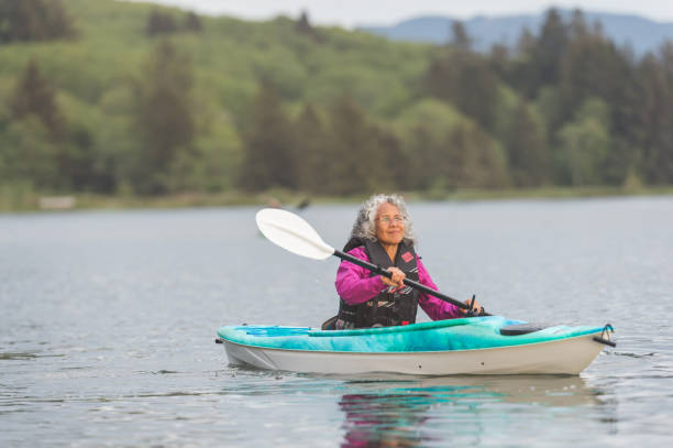 istock Senior ethnic woman kayaking solo on the river 933972326