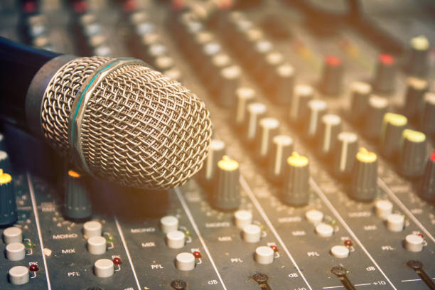 istock Wireless microphone on the audio mixer in the conference room. 933998644