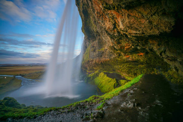 istock Big cave behind The Seljalandsfoss waterfall in Iceland with beautiful evening sky as background 934003516