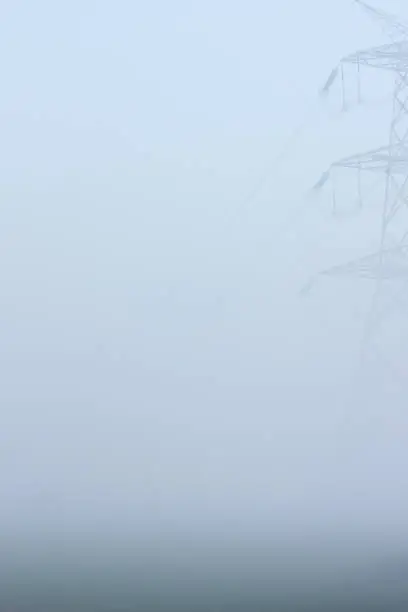 Image of a high tension transmission tower in a winter morning at Tirunelveli. There has been too much fog that covered the view beyond 20 ft, on that day.