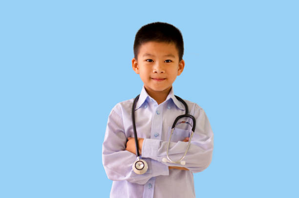 istock Asian boy pretend doctor with stethoscope selective focus isolated on light blue background with clipping path. 934032840