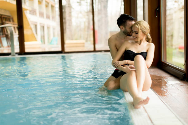 istock Loving couple relaxing in the spa by the pool 934040838