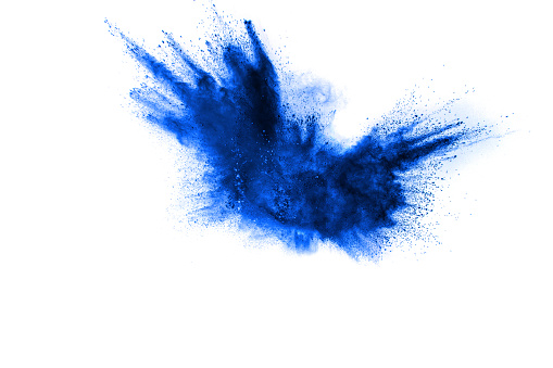 Blue color powder explosion cloud isolated on white background.Closeup of Blue dust particles splash isolated on  background.