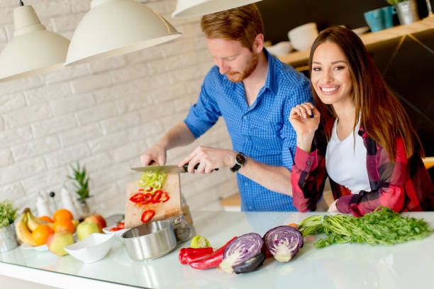 istock Young couple preparing healthy meal in the kitchen 934046058