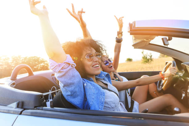 Girlfriends having fun on road trip Girlfriends having fun on road trip convertible stock pictures, royalty-free photos & images