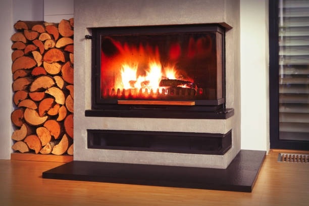 Detail of modern fireplace and firewood in living room