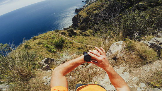 POV of a Man trail running offroad in a mountain forest