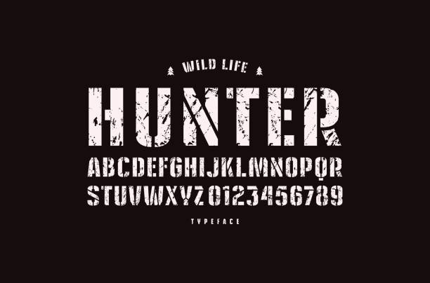 Original stencil-plate sans serif font Original stencil-plate sans serif font. Bold face. Letters and numbers with rough texture for label and emblem design. White print on black background sans font stock illustrations