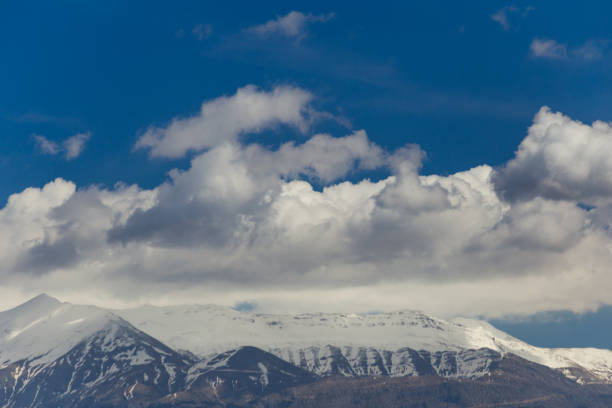 istock mountain peak snow clouds blue sky, epirus Ioannina Greece Mitsikeli peak mountain 934073642