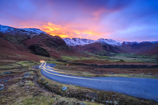 Long exposure vehicle light trails in the Langdale Valley Long exposure vehicle light trails in the Langdale Valley, The Lake District, Cumbria, England keswick stock pictures, royalty-free photos & images