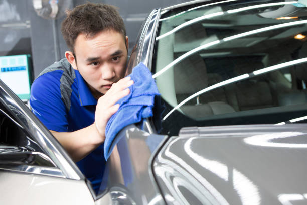 istock man washing car with a cloth 934086978