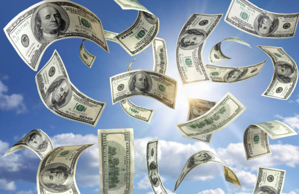 Money falling from the sky stock photo